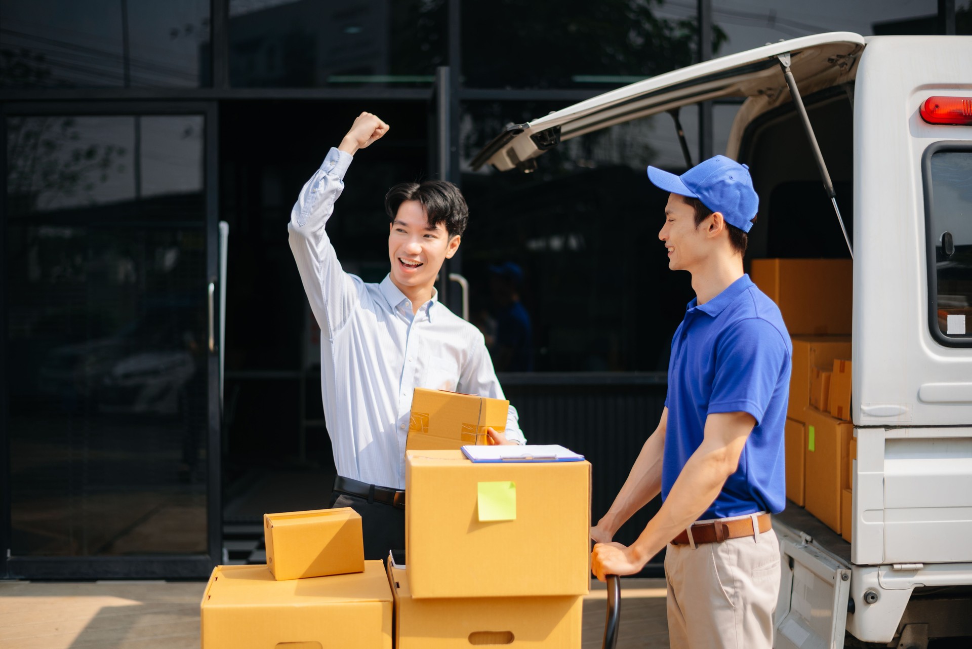 Delivery Asian man by sending box of parcel to customers service at home